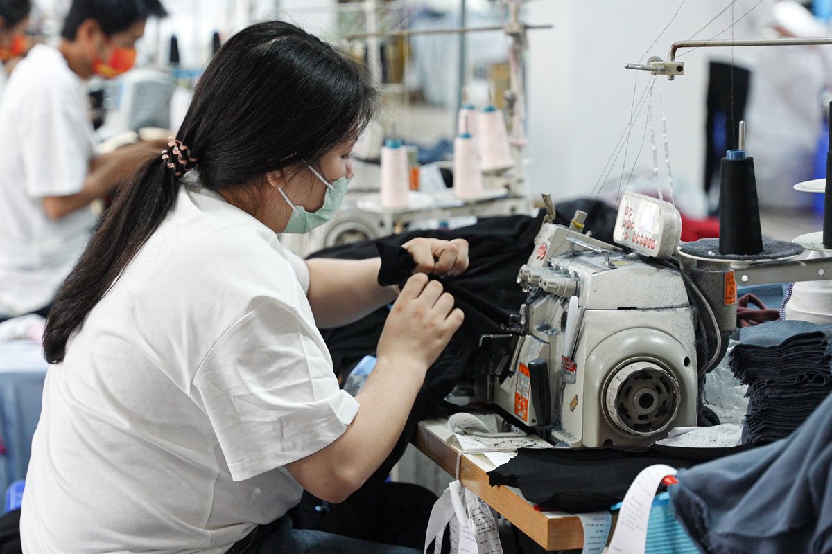 Factory sewing machine working on hoodie seams